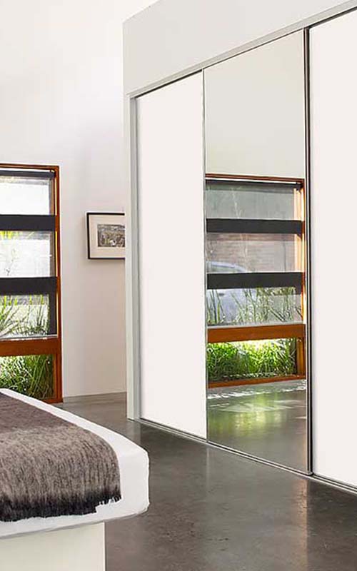 Mirrored wardrobe doors in modern bedroom