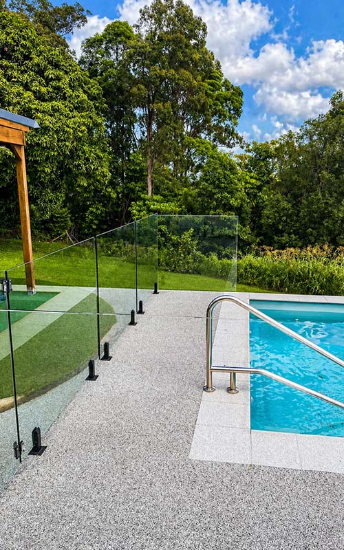 Frameless glass pool fencing around outdoor pool