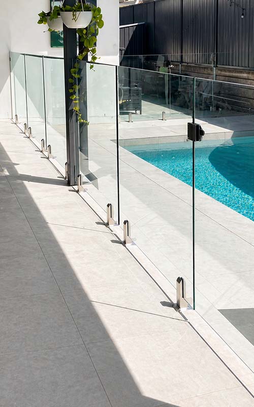 Frameless glass pool fencing beside residential pool