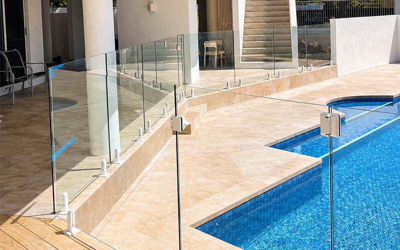 Frameless glass pool fencing beside swimming pool
