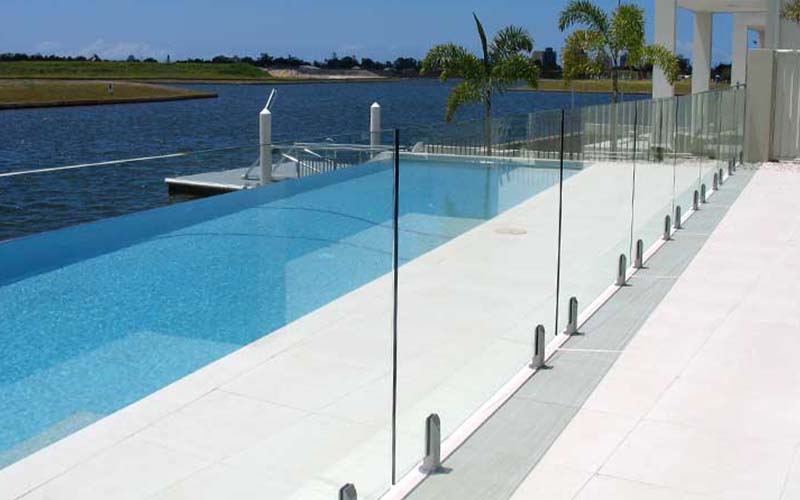 Frameless glass pool fencing overlooking the water