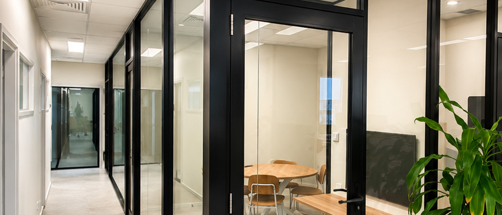 Black framed glass office partitions and meeting room