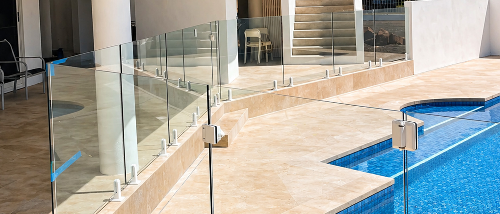 Frameless glass pool fencing beside waterfront pool
