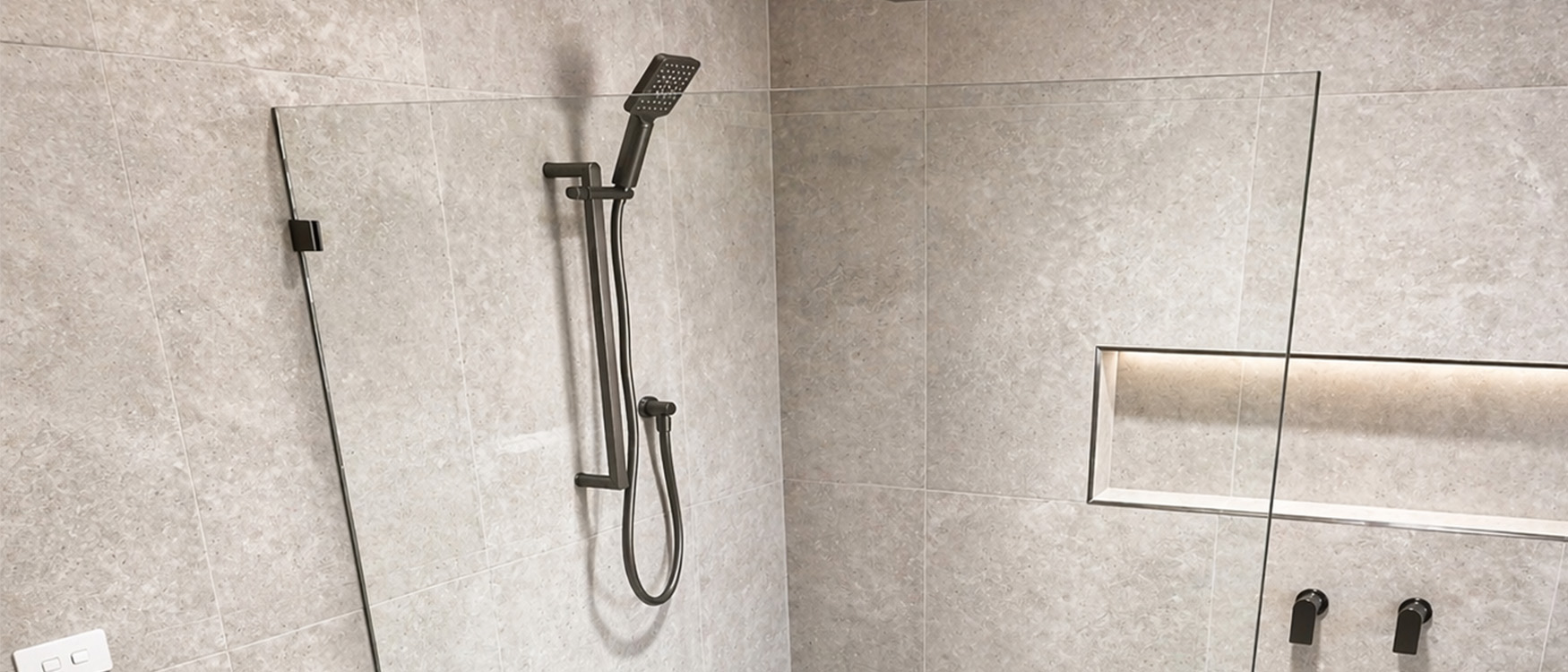 Frameless glass shower screen in modern bathroom